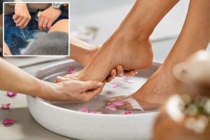 A person's feet soaking in a bowl of water